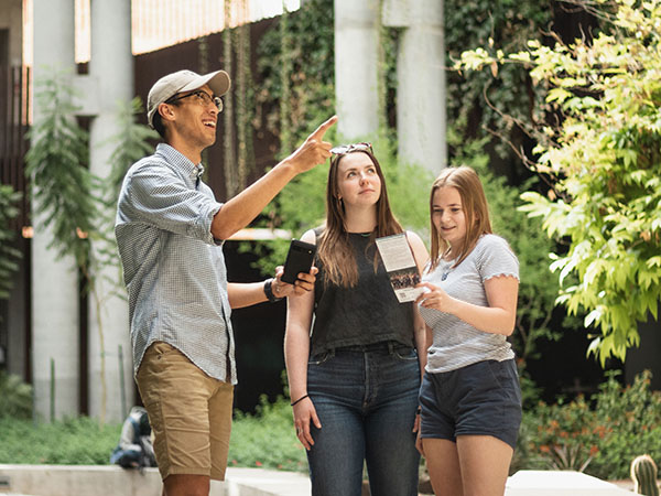 Three people looking around the Environmental and Natural Resources 2 building