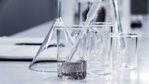 images of glass chemistry beakers in a lab